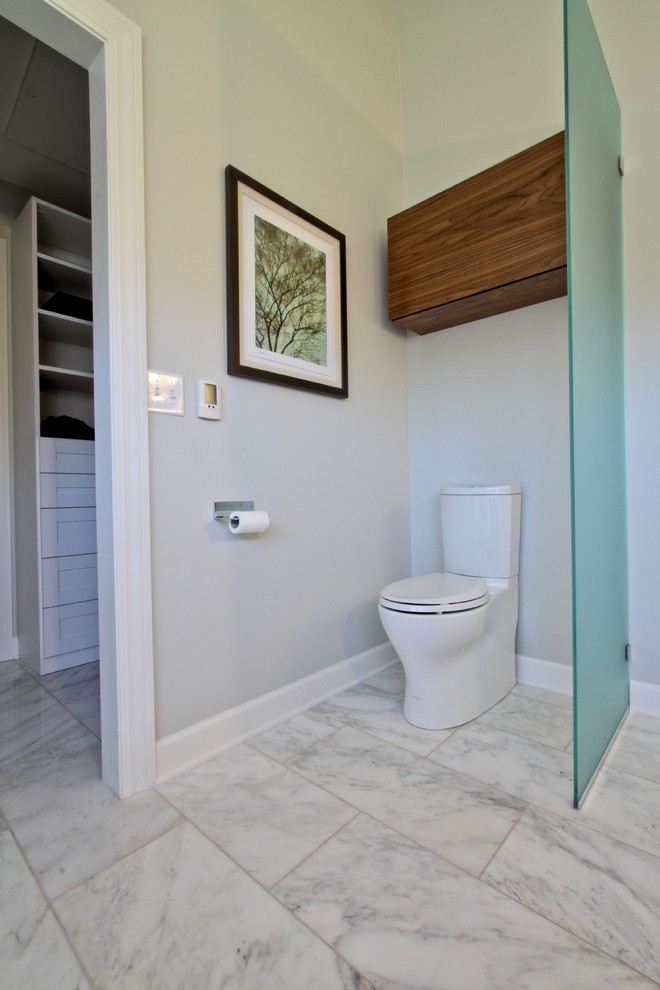 Example of a trendy white tile and stone tile bathroom design in Indianapolis with flat-panel cabinets, medium tone wood cabinets and a two-piece toilet