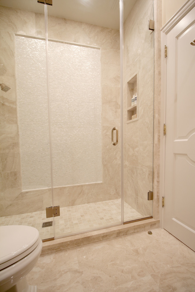 Example of a mid-sized transitional 3/4 beige tile and stone tile marble floor doorless shower design in New York with raised-panel cabinets, dark wood cabinets, a one-piece toilet, beige walls, an undermount sink and marble countertops