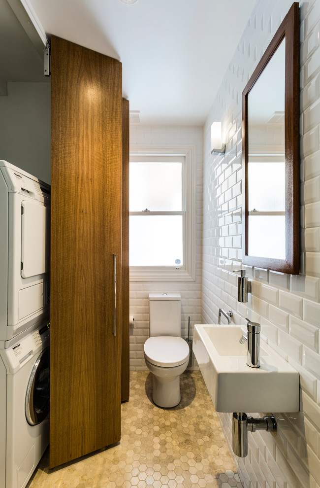 Example of a small trendy white tile and ceramic tile porcelain tile bathroom design in Sydney with a wall-mount sink, flat-panel cabinets, medium tone wood cabinets, a two-piece toilet and white walls