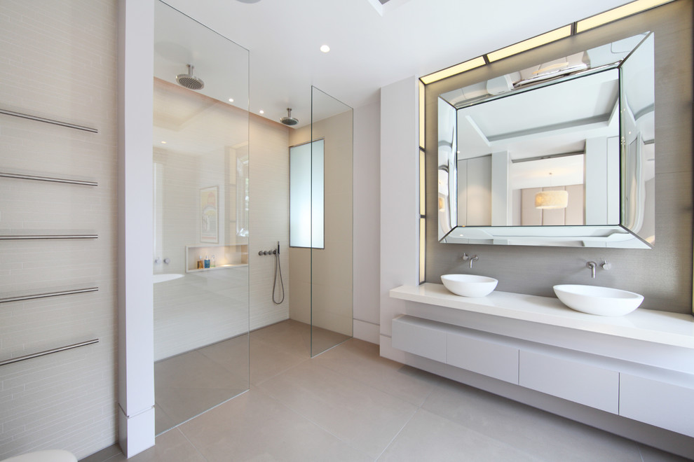 Inspiration for a large contemporary ensuite bathroom in London with flat-panel cabinets, grey cabinets, a freestanding bath, a double shower, a wall mounted toilet, grey tiles, porcelain tiles, grey walls, porcelain flooring and quartz worktops.