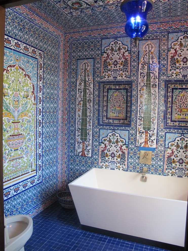 Mediterranean bathroom in New York with a freestanding bath, multi-coloured tiles, multi-coloured walls and mosaic tile flooring.