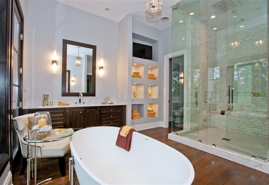 Example of a large trendy master gray tile and stone tile dark wood floor bathroom design in Chicago with recessed-panel cabinets, dark wood cabinets, gray walls, an undermount sink, marble countertops and a hinged shower door