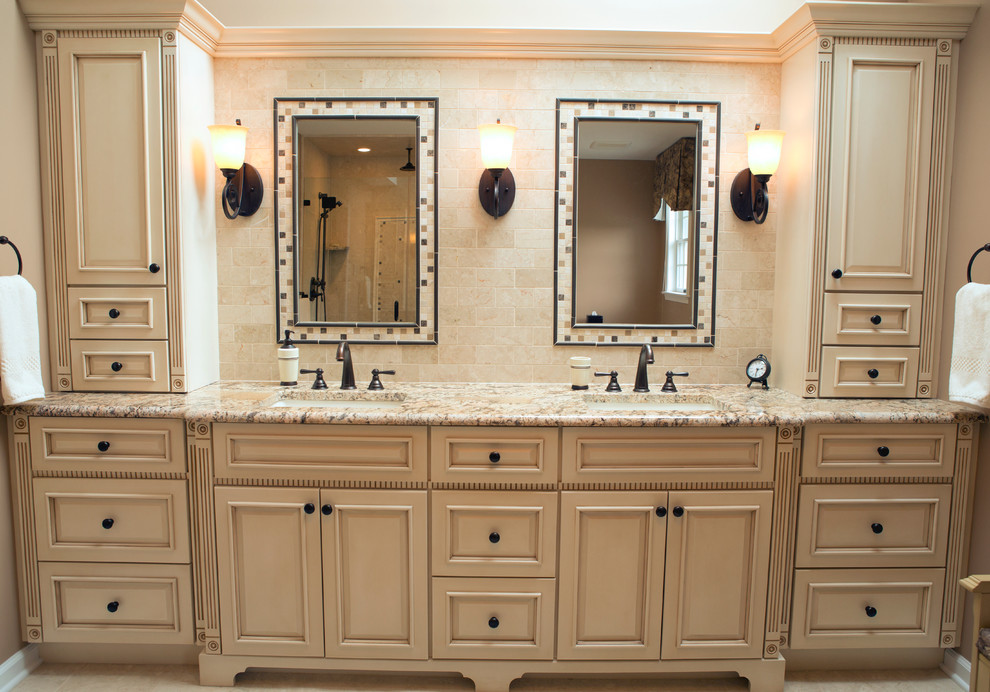 Bathroom - mid-sized traditional 3/4 beige tile, gray tile, multicolored tile and stone slab ceramic tile bathroom idea in Philadelphia with raised-panel cabinets, beige cabinets, a one-piece toilet, beige walls, a drop-in sink and solid surface countertops