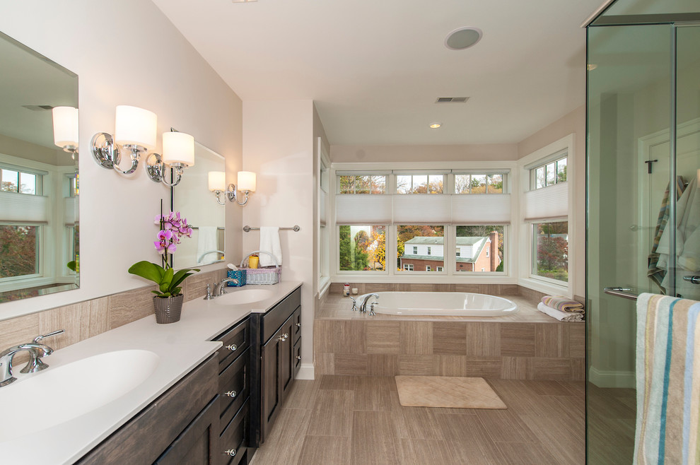 Inspiration for a mid-sized transitional master beige tile and porcelain tile porcelain tile bathroom remodel in DC Metro with an undermount sink, flat-panel cabinets, dark wood cabinets, quartz countertops and a two-piece toilet