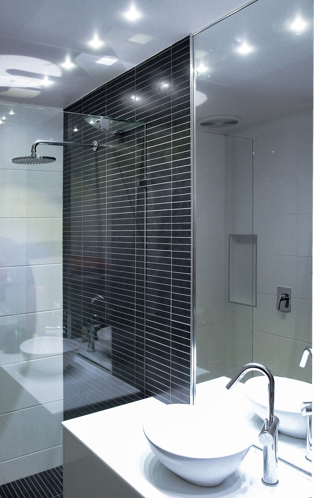 Small contemporary bathroom in Adelaide with white cabinets, an alcove shower, grey tiles, matchstick tiles, white walls, ceramic flooring, a vessel sink, engineered stone worktops, grey floors, a hinged door and white worktops.