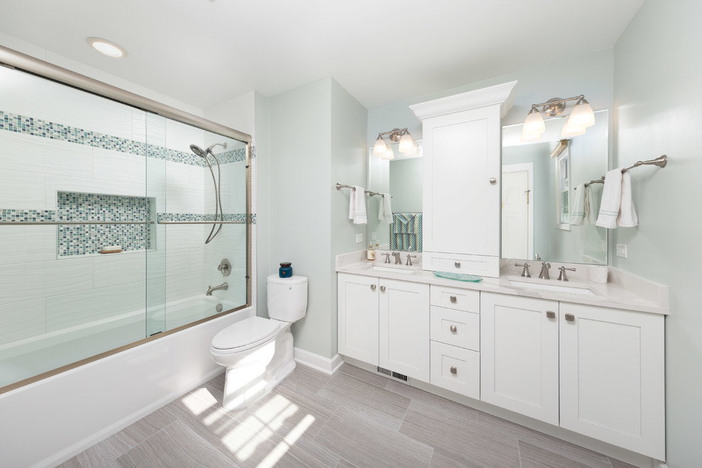 Inspiration for a mid-sized contemporary master multicolored tile and ceramic tile medium tone wood floor bathroom remodel in Chicago with flat-panel cabinets, white cabinets, a one-piece toilet, an undermount sink, limestone countertops and green walls