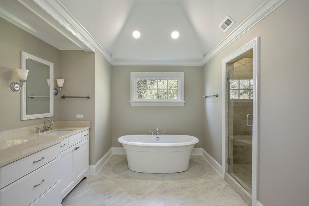 Mid-sized transitional master beige tile and stone tile marble floor bathroom photo in Chicago with beaded inset cabinets, white cabinets, a one-piece toilet, gray walls and limestone countertops