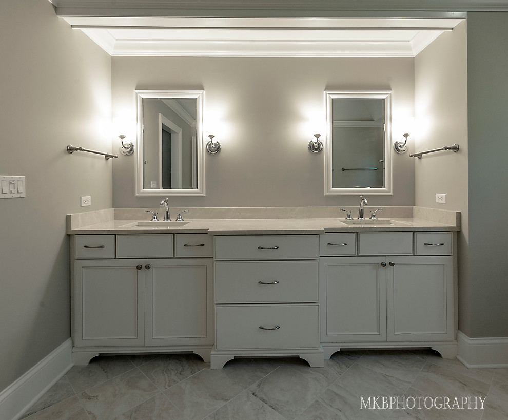 Inspiration for a medium sized classic ensuite bathroom in Chicago with beaded cabinets, white cabinets, limestone worktops, a freestanding bath, an alcove shower, a one-piece toilet, beige tiles, stone tiles, grey walls, marble flooring and a submerged sink.