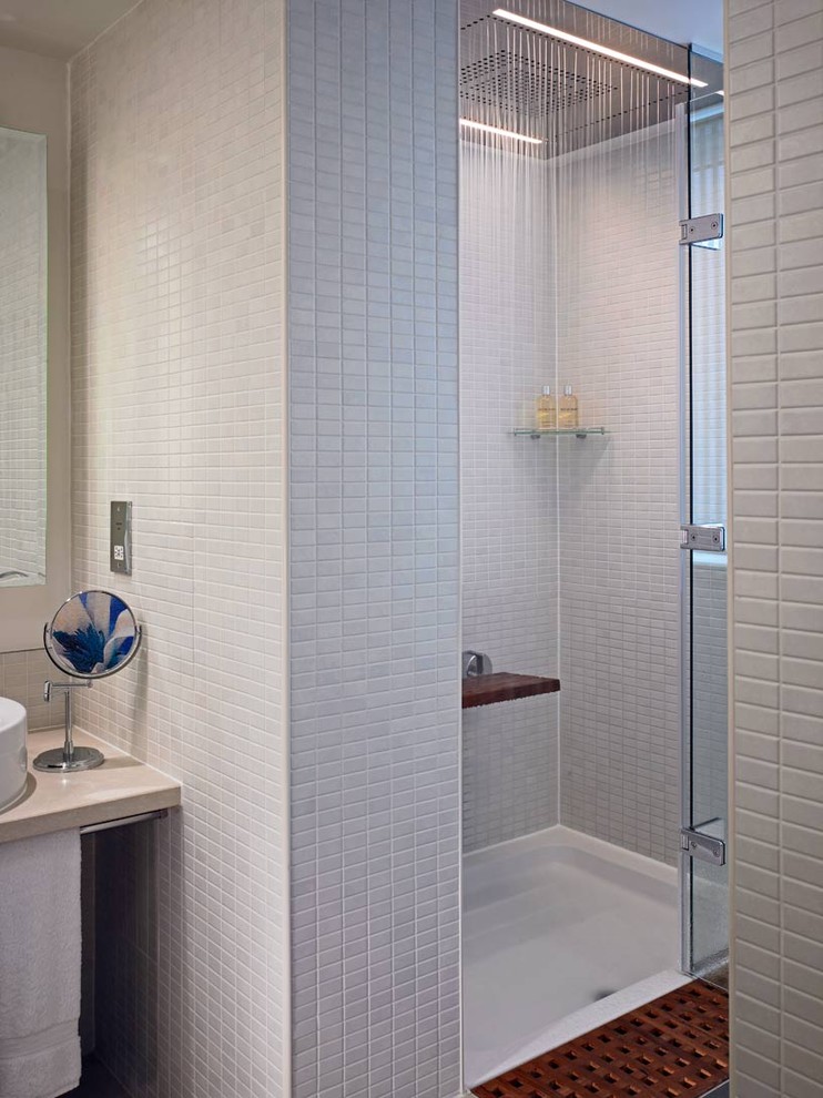 Example of a minimalist gray tile alcove shower design in London