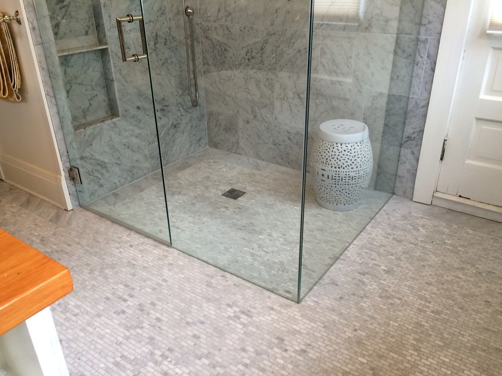 Mid-sized minimalist master white tile and marble tile mosaic tile floor and gray floor walk-in shower photo in Denver with beige walls and a hinged shower door