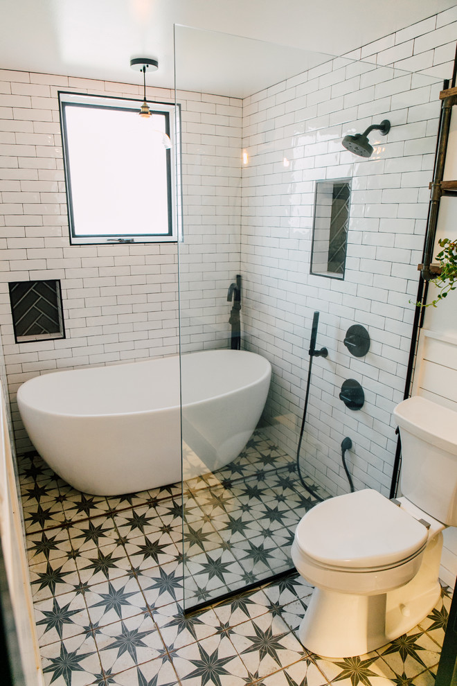 Inspiration for a small eclectic bathroom in Seattle with shaker cabinets, black cabinets, a freestanding bath, a walk-in shower, white tiles, ceramic tiles, white walls, cement flooring, a submerged sink, engineered stone worktops, multi-coloured floors, an open shower and white worktops.