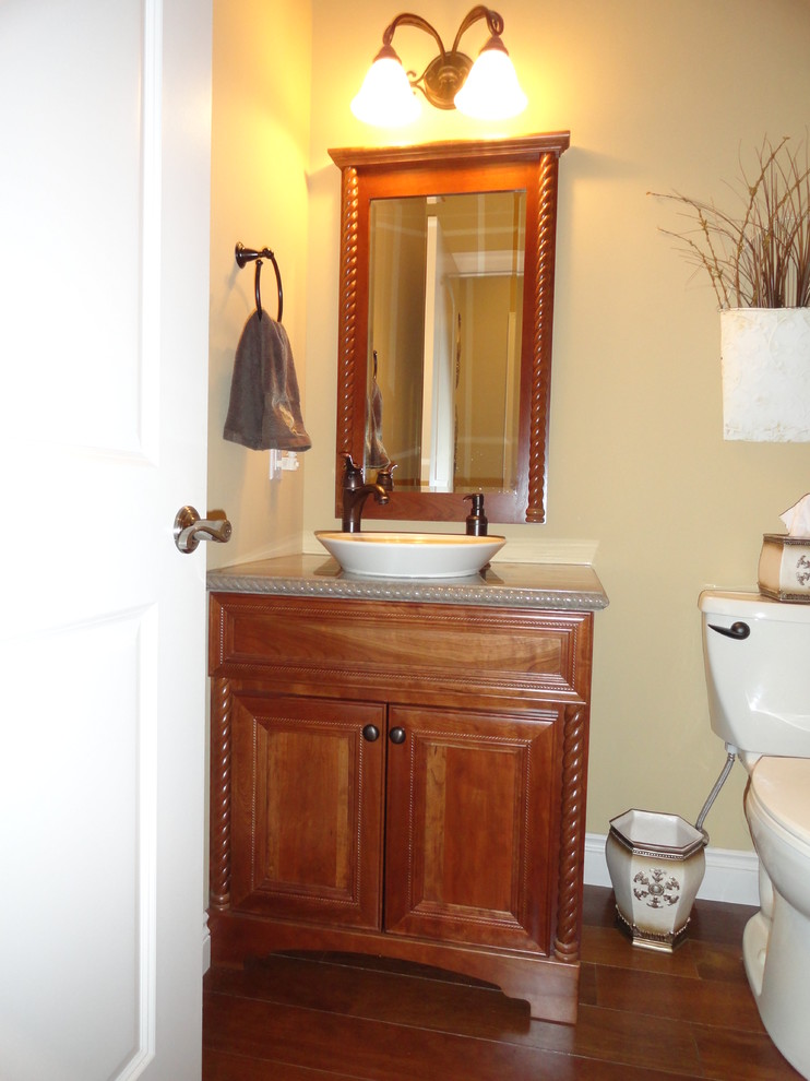 Inspiration for a small eclectic shower room bathroom in St Louis with a vessel sink, freestanding cabinets, dark wood cabinets, marble worktops, a two-piece toilet, beige walls and medium hardwood flooring.