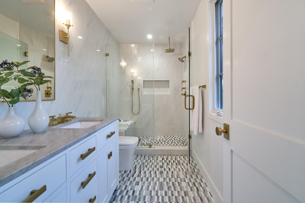 This is an example of a medium sized modern ensuite bathroom in Los Angeles with shaker cabinets, white cabinets, a one-piece toilet, white tiles, ceramic tiles, mosaic tile flooring, marble worktops, multi-coloured floors, grey worktops, a shower bench, double sinks and a freestanding vanity unit.