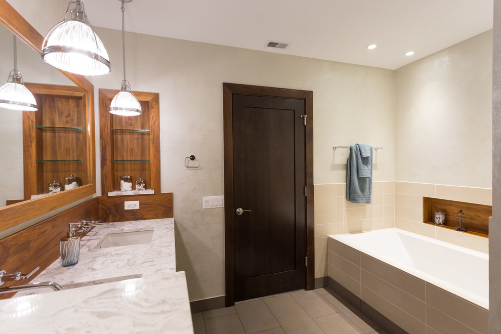Example of a mid-sized transitional master white tile and ceramic tile ceramic tile bathroom design in Chicago with flat-panel cabinets, medium tone wood cabinets, a two-piece toilet, white walls, an undermount sink and marble countertops