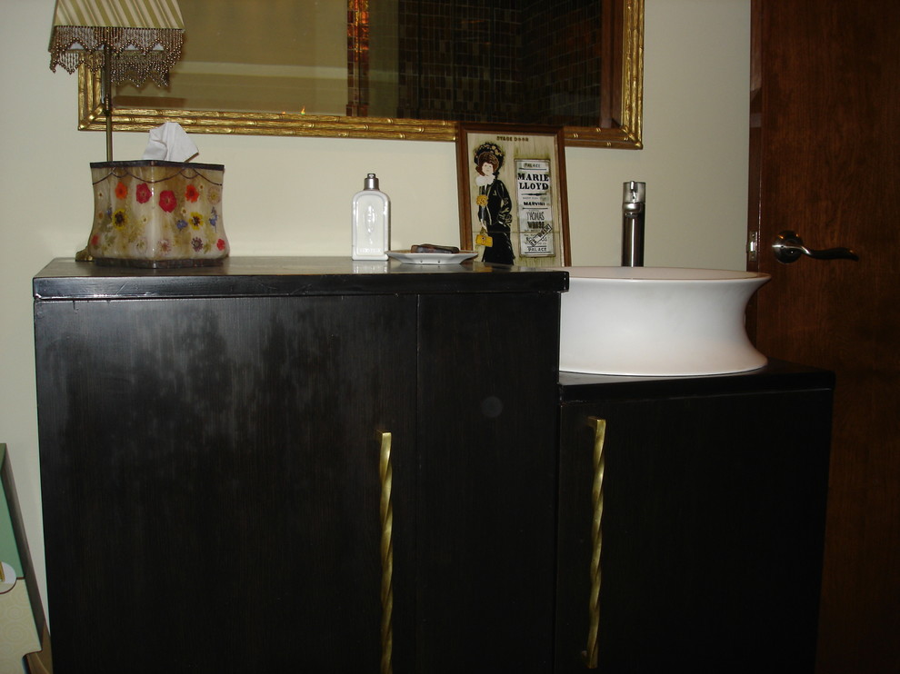 Photo of a medium sized traditional bathroom in Chicago with freestanding cabinets, dark wood cabinets, beige walls, ceramic flooring, a vessel sink and wooden worktops.