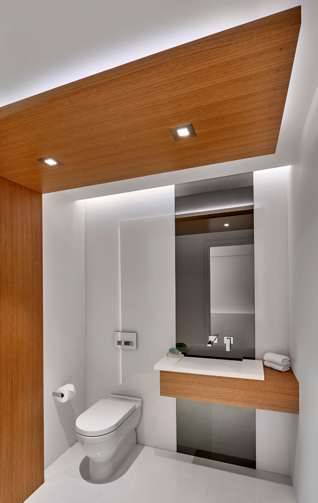 Exemple d'une salle de bain tendance avec un mur blanc, un plan vasque, un plan de toilette en bois, un sol blanc et un plan de toilette marron.