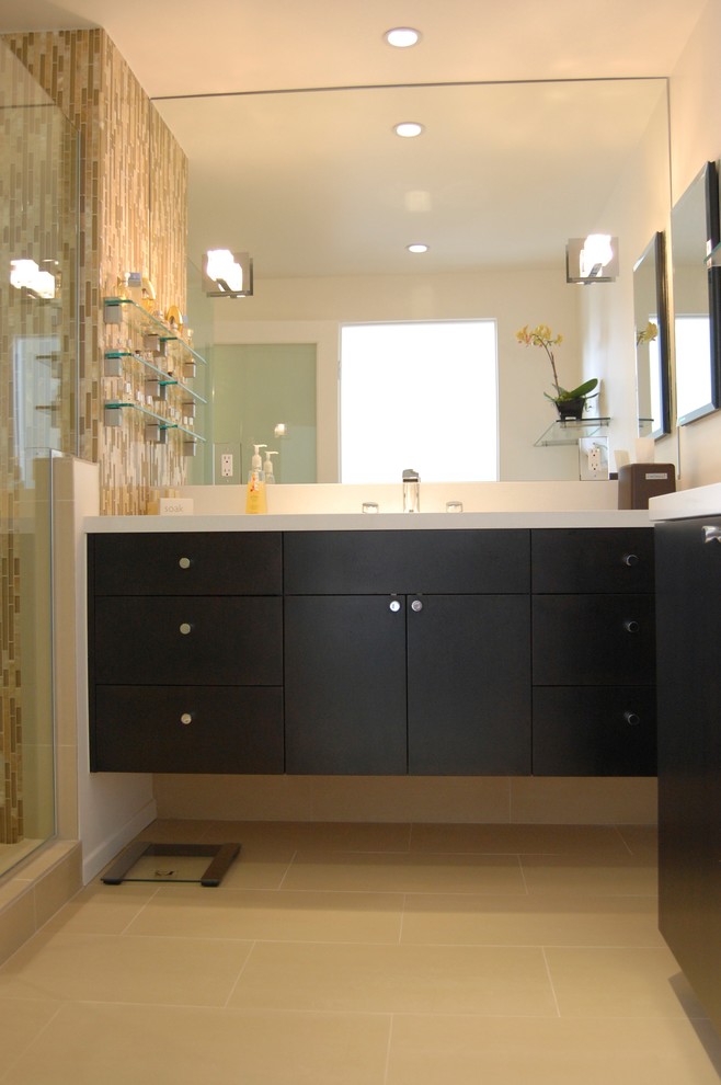 This is an example of a medium sized modern shower room bathroom in Los Angeles with flat-panel cabinets, dark wood cabinets, a corner shower, a one-piece toilet, beige tiles, glass tiles, white walls, porcelain flooring, a submerged sink and quartz worktops.