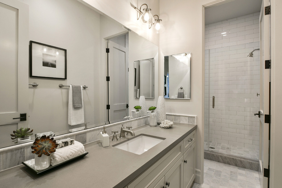 Design ideas for a large mediterranean ensuite bathroom in San Francisco with recessed-panel cabinets, grey cabinets, a freestanding bath, an alcove shower, a one-piece toilet, grey tiles, metro tiles, grey walls, ceramic flooring, a submerged sink and quartz worktops.