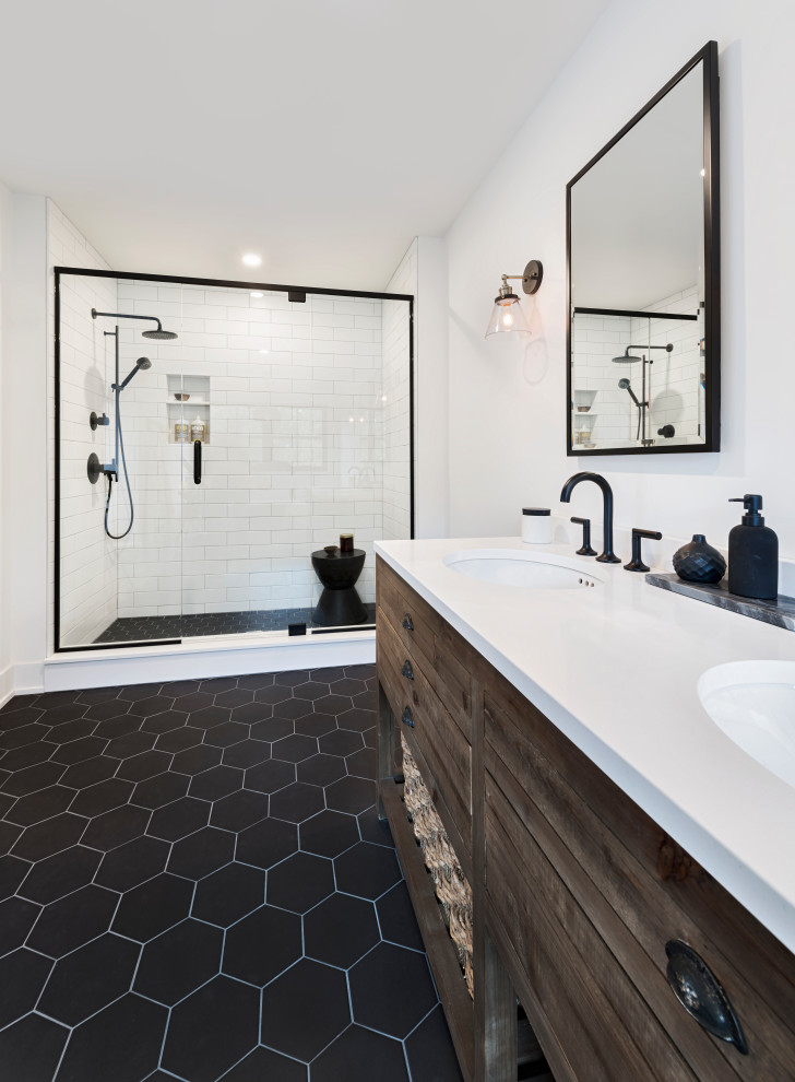Inspiration for a rural bathroom in Ottawa with dark wood cabinets, an alcove shower, white tiles, metro tiles, white walls, a submerged sink, black floors, a hinged door, white worktops and double sinks.
