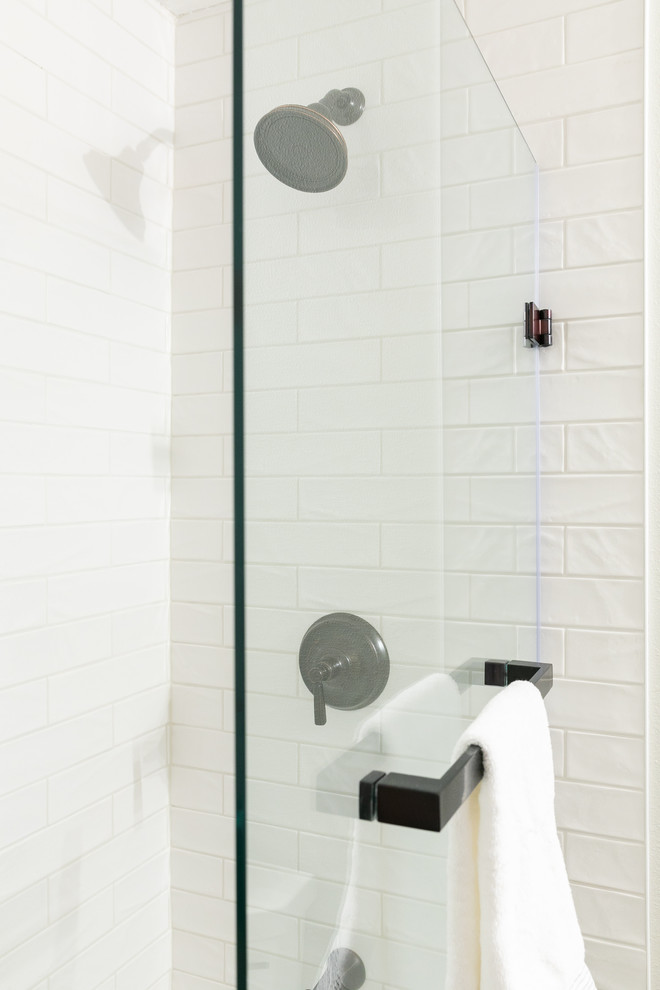 Mid-sized trendy master white tile and ceramic tile mosaic tile floor bathroom photo in Denver with shaker cabinets, medium tone wood cabinets, a one-piece toilet, white walls, an undermount sink, marble countertops, a hinged shower door and beige countertops