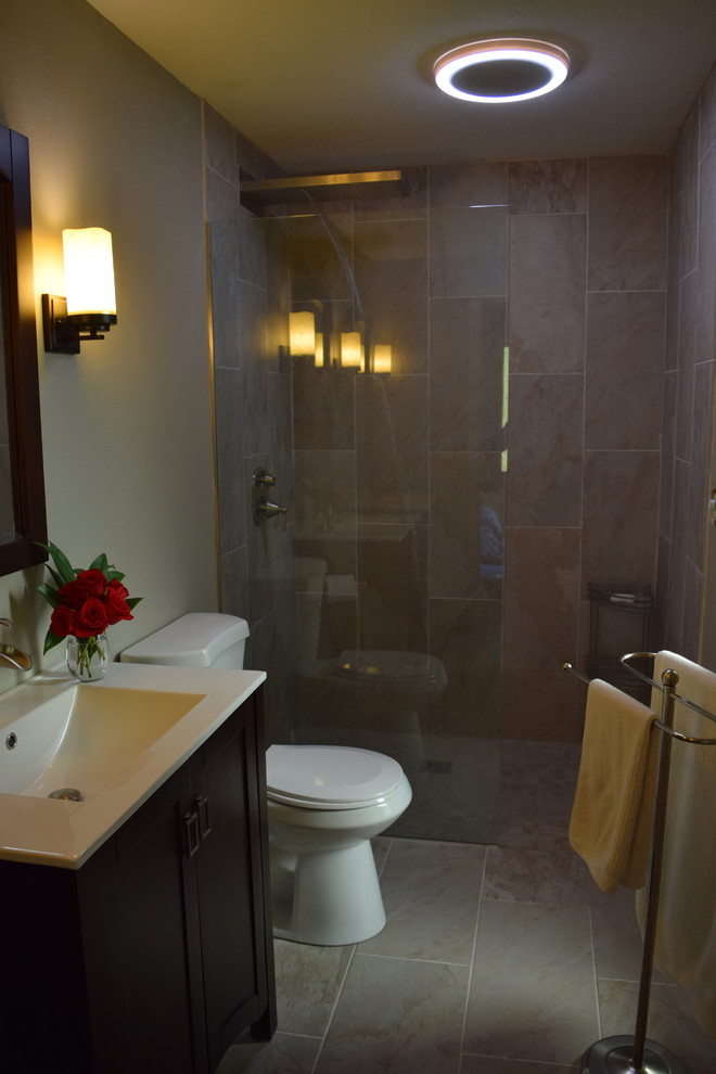 Mid-sized tuscan master beige tile and porcelain tile porcelain tile walk-in shower photo in Seattle with a drop-in sink, furniture-like cabinets, dark wood cabinets, solid surface countertops, a one-piece toilet and gray walls