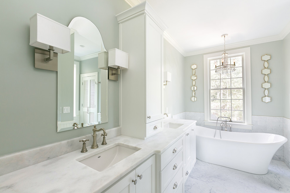 Design ideas for a medium sized classic ensuite bathroom in Charleston with shaker cabinets, white cabinets, a freestanding bath, an alcove shower, a one-piece toilet, white tiles, marble tiles, grey walls, marble flooring, a submerged sink, marble worktops, white floors and a hinged door.