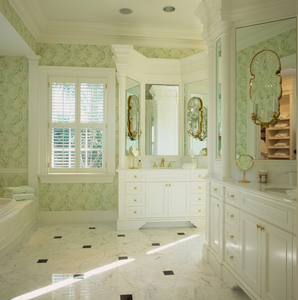 Large traditional bathroom in Miami with a submerged sink, white cabinets, marble worktops, a built-in bath, white tiles, green walls, marble flooring and recessed-panel cabinets.