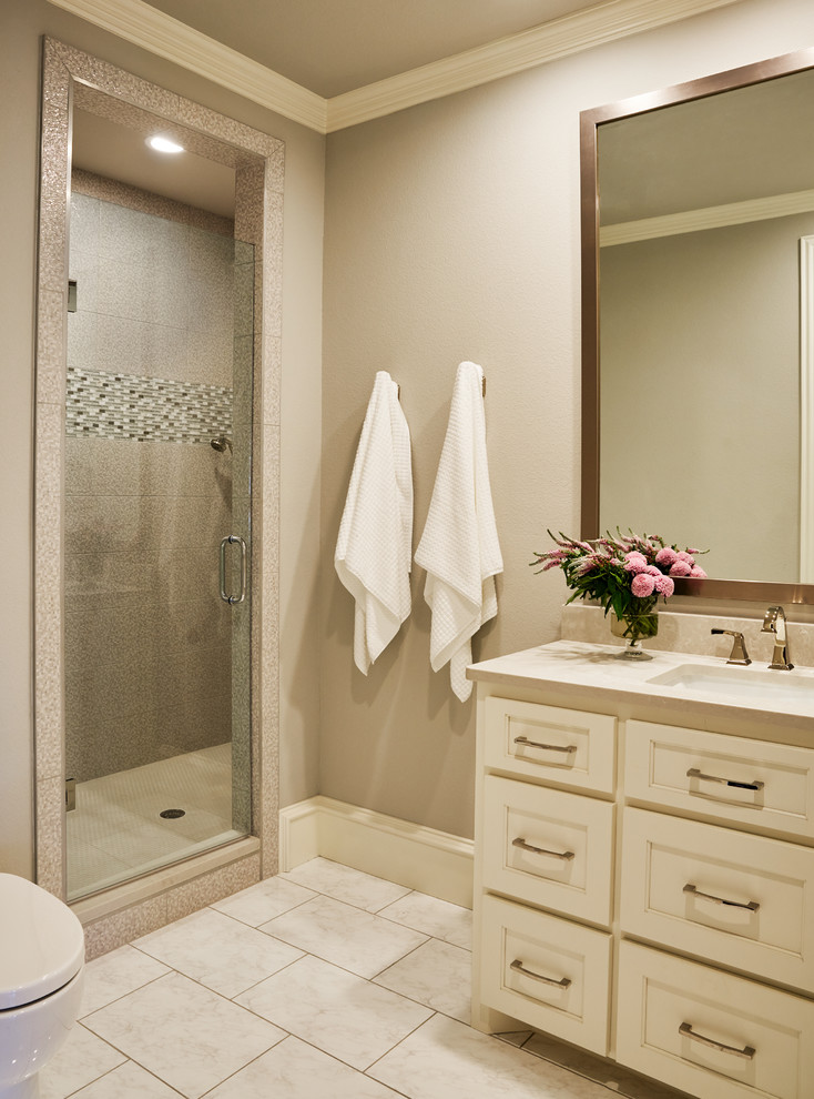 Example of a mid-sized classic white tile and stone tile porcelain tile and white floor bathroom design in Other with recessed-panel cabinets, white cabinets, a one-piece toilet, gray walls, an undermount sink, quartz countertops and a hinged shower door
