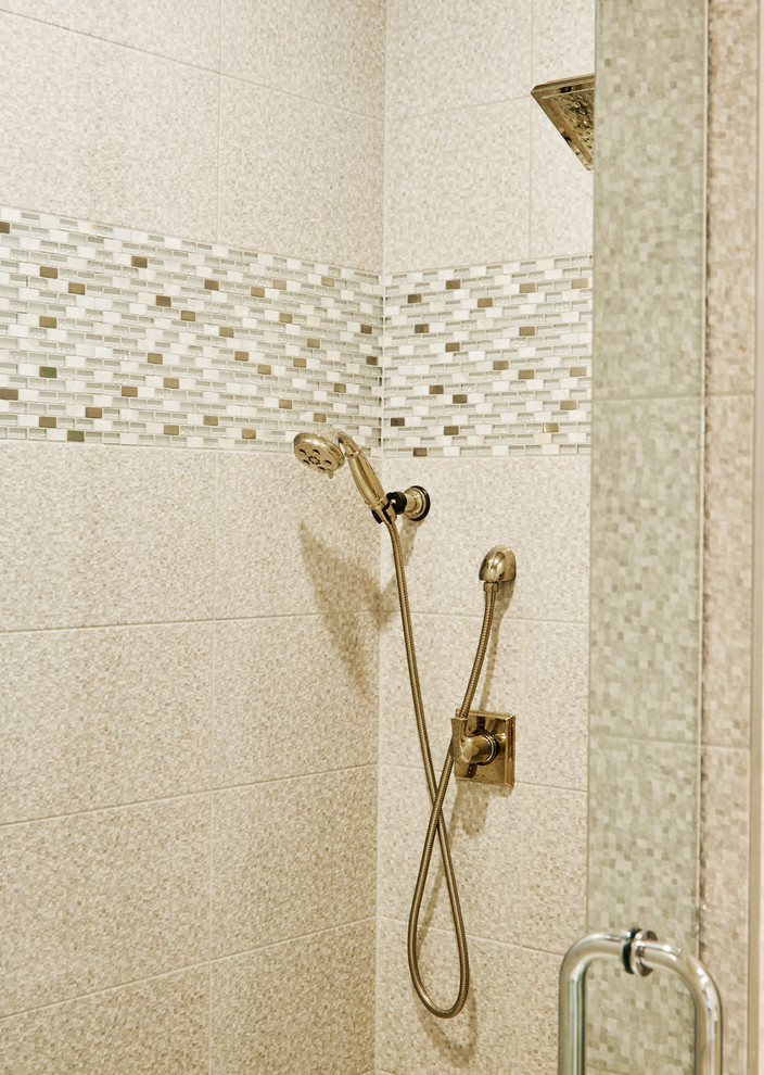 Mid-sized elegant master stone tile and beige tile porcelain tile and beige floor corner shower photo in Other with a hinged shower door and beige walls