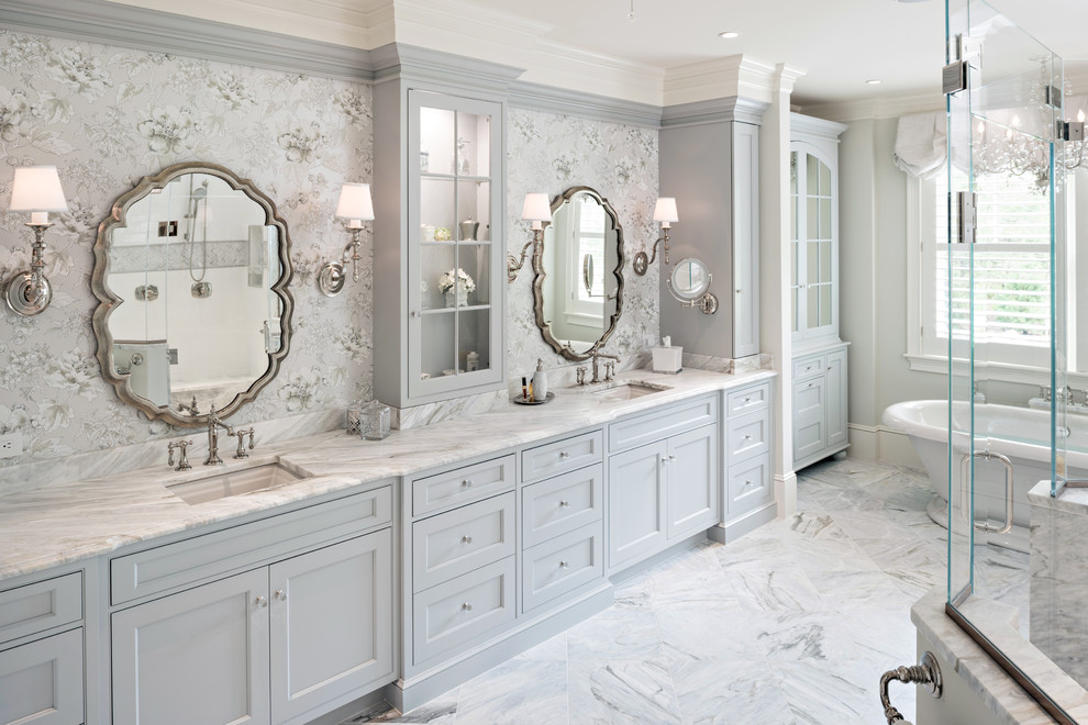 Design ideas for an expansive traditional ensuite bathroom in Boston with grey cabinets, a freestanding bath, grey walls, marble flooring, marble worktops, grey floors, a hinged door, recessed-panel cabinets and a submerged sink.