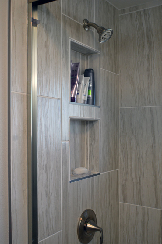 Small traditional shower room bathroom in Seattle with raised-panel cabinets, white cabinets, an alcove shower, a two-piece toilet, porcelain tiles, a submerged sink, vinyl flooring and solid surface worktops.