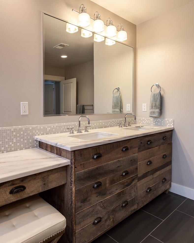 Design ideas for an expansive contemporary ensuite bathroom in Denver with flat-panel cabinets, distressed cabinets, a freestanding bath, a walk-in shower, beige tiles, ceramic tiles, grey walls, medium hardwood flooring, a submerged sink and granite worktops.