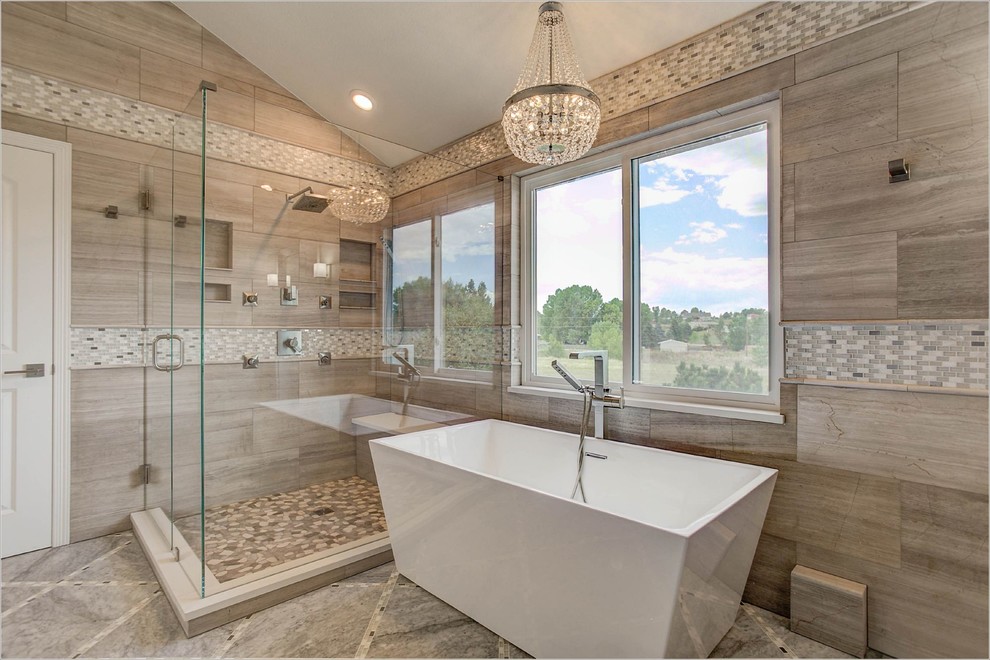 Large contemporary ensuite bathroom in Denver with a freestanding bath, a corner shower, a hinged door, brown tiles, beige tiles, shaker cabinets, white cabinets, porcelain tiles, beige walls, ceramic flooring, a submerged sink and brown floors.