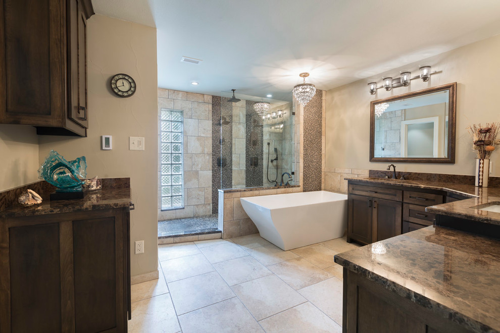 Medium sized traditional shower room bathroom in Dallas with shaker cabinets, dark wood cabinets, a freestanding bath, a walk-in shower, a one-piece toilet, beige tiles, mosaic tiles, brown walls, limestone flooring, a submerged sink, granite worktops, beige floors and an open shower.