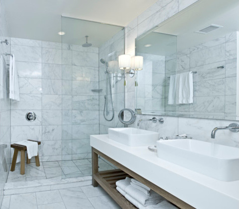 Modelo de cuarto de baño actual con encimera de cuarzo compacto y baldosas y/o azulejos blancos