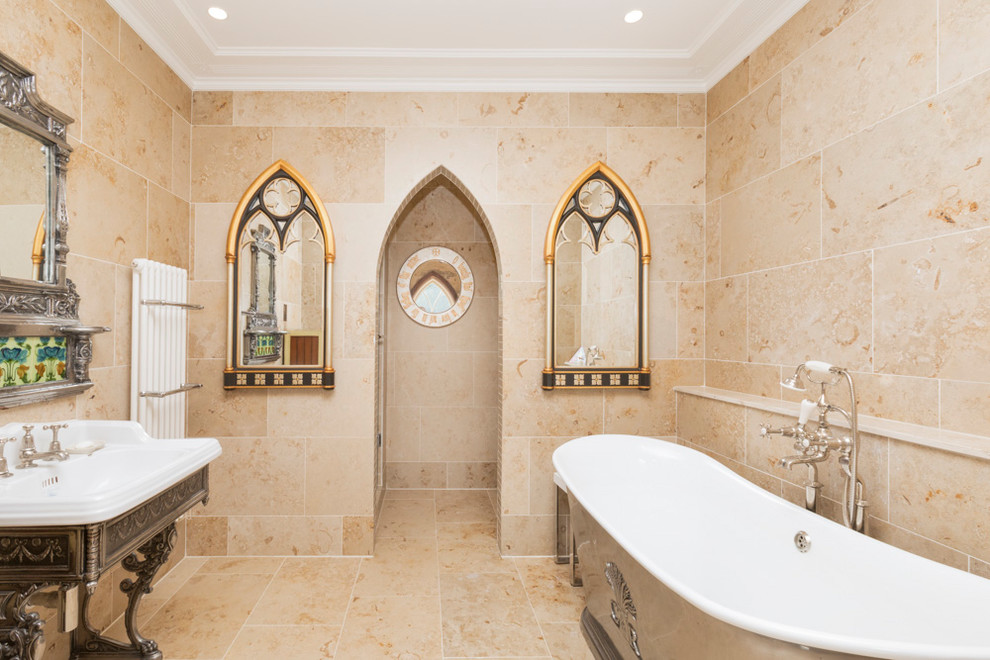 Photo of a medium sized mediterranean ensuite bathroom in Kent with a freestanding bath, a pedestal sink, beige tiles and beige floors.