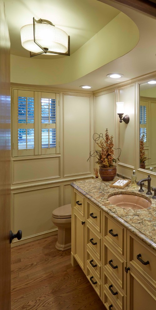 Small elegant 3/4 light wood floor drop-in bathtub photo in Jacksonville with an undermount sink, recessed-panel cabinets, beige cabinets, quartz countertops, a one-piece toilet and beige walls