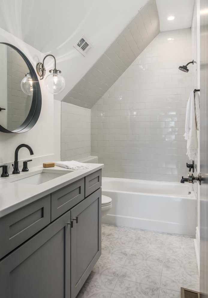 Example of a mid-sized ornate kids' white tile and subway tile porcelain tile and black floor bathroom design in Nashville with shaker cabinets, gray cabinets, a two-piece toilet, white walls, an undermount sink, quartz countertops and white countertops