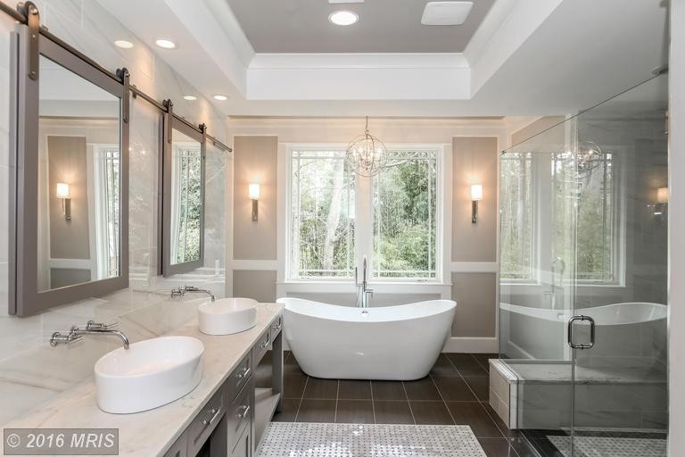Large transitional master bathroom photo in DC Metro with recessed-panel cabinets, beige walls, a vessel sink and marble countertops