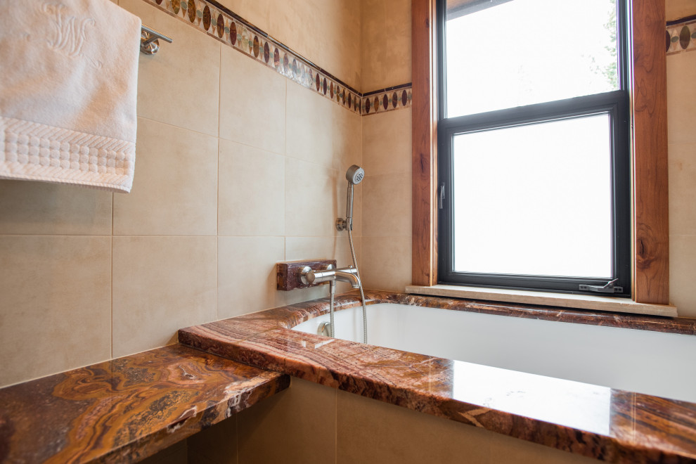 Large mountain style master beige tile ceramic tile and double-sink double shower photo in Denver with medium tone wood cabinets, granite countertops, a hinged shower door and beige countertops