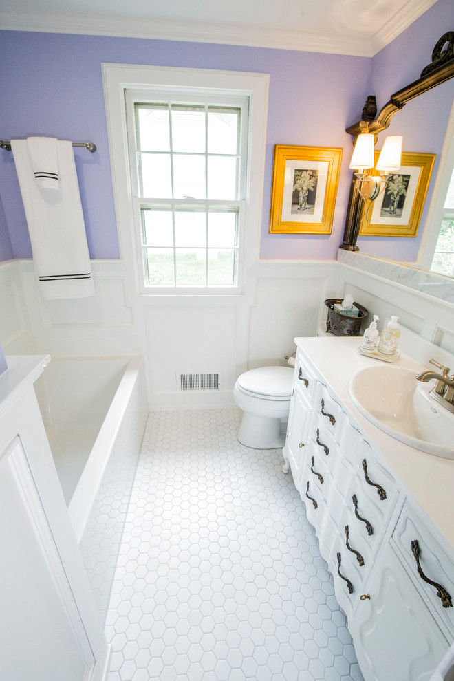 Foto på ett litet eklektiskt badrum, med möbel-liknande, vita skåp, ett badkar i en alkov, en toalettstol med separat cisternkåpa, lila väggar, klinkergolv i keramik, ett nedsänkt handfat, bänkskiva i onyx och vitt golv