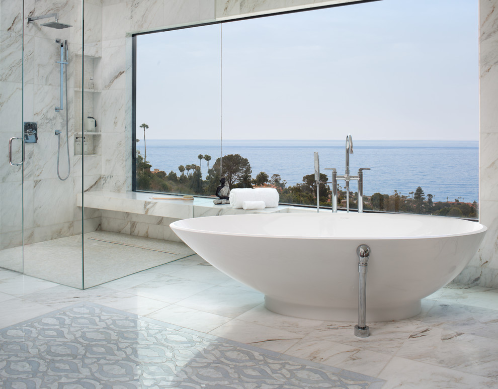 Design ideas for an expansive coastal ensuite bathroom in San Diego with a freestanding bath, a built-in shower, marble tiles, marble flooring, a hinged door, white tiles and white floors.