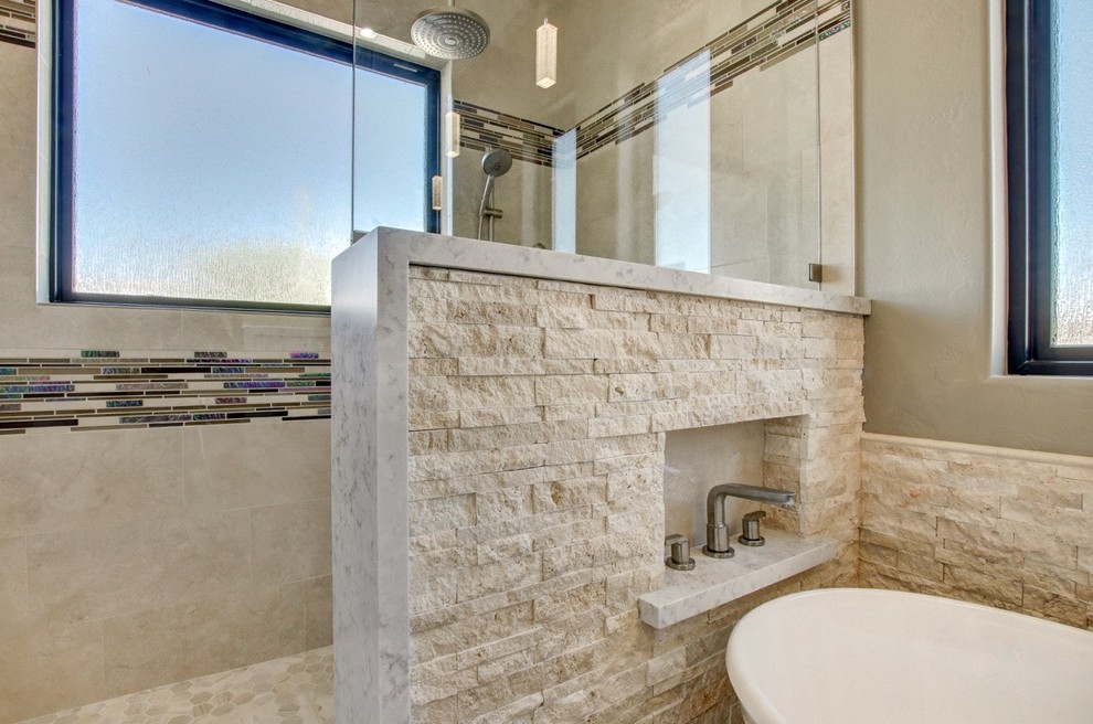 Bathroom - mid-sized contemporary master beige tile and stone tile porcelain tile and beige floor bathroom idea in Phoenix with flat-panel cabinets, light wood cabinets, a two-piece toilet, beige walls, an undermount sink, quartz countertops and white countertops