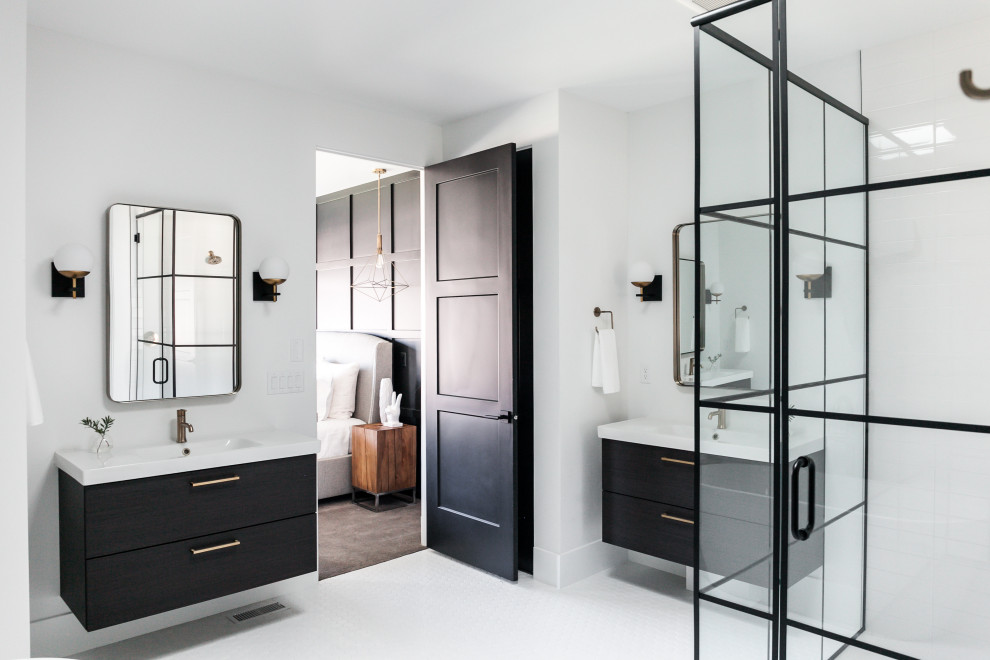 Design ideas for a traditional bathroom in Denver with flat-panel cabinets, black cabinets, a corner shower, white tiles, white walls, mosaic tile flooring, an integrated sink, white floors, a hinged door and white worktops.