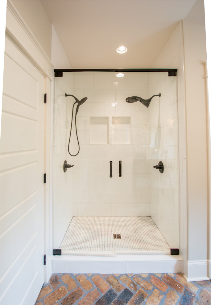 Medium sized classic ensuite bathroom in Atlanta with open cabinets, distressed cabinets, white tiles, metro tiles, beige walls, brick flooring, a submerged sink, wooden worktops, multi-coloured floors, a hinged door and brown worktops.