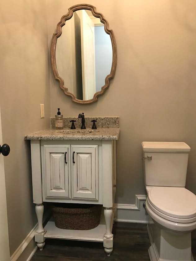Kleines Klassisches Badezimmer mit profilierten Schrankfronten, weißen Schränken, Wandtoilette mit Spülkasten, beiger Wandfarbe, Unterbauwaschbecken und Granit-Waschbecken/Waschtisch in New Orleans