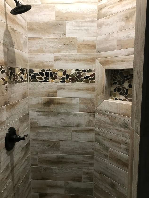 Elegant brown tile and porcelain tile corner shower photo in New Orleans with an undermount sink