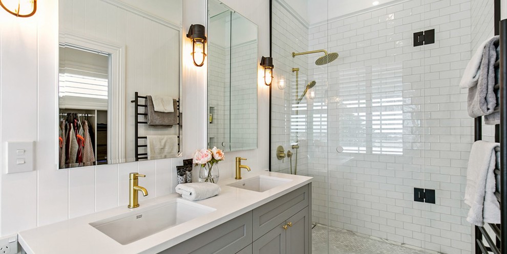 Large victorian wet room bathroom in Auckland with shaker cabinets, grey cabinets, a one-piece toilet, white tiles, porcelain tiles, white walls, marble flooring, an integrated sink, soapstone worktops, white floors, an open shower and white worktops.