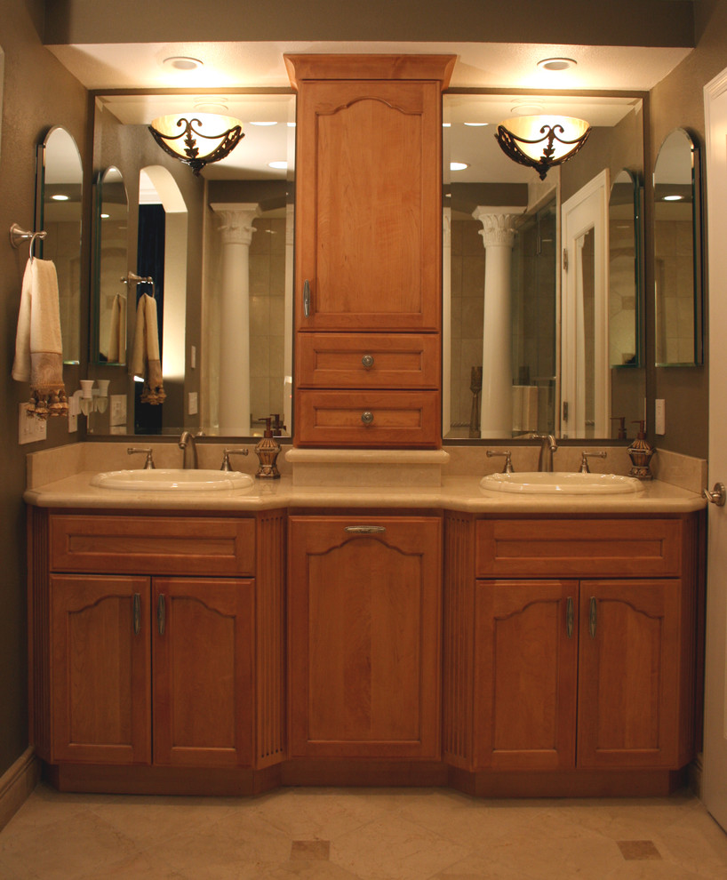 This is an example of a traditional bathroom in San Francisco with beaded cabinets, light wood cabinets, a hot tub, a one-piece toilet, a built-in sink, beige floors and beige worktops.