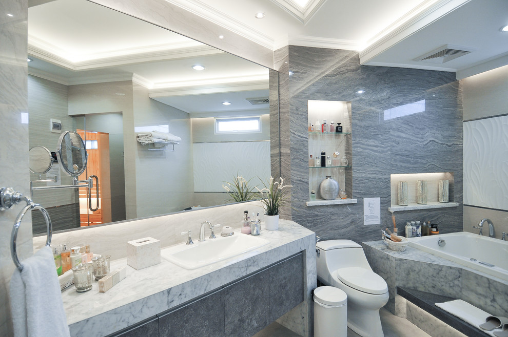 Идея дизайна: большая главная ванная комната в стиле кантри с фасадами островного типа, серыми фасадами, гидромассажной ванной, душем в нише, унитазом-моноблоком, серой плиткой, плиткой из листового камня, серыми стенами, полом из керамической плитки, накладной раковиной и мраморной столешницей